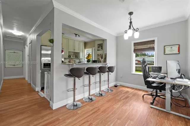 a view of a dining room with furniture window and wooden floor