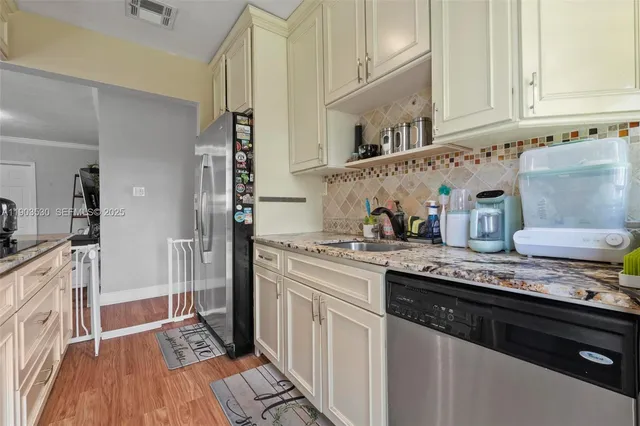 a kitchen with stainless steel appliances granite countertop a stove and a microwave