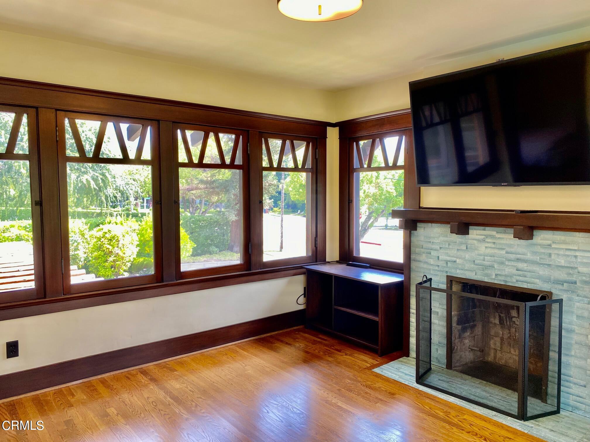 1361 Ridge Way Pasadena, CA 91106 - Photo 15 of 31 a living room with fireplace furniture and a floor to ceiling window