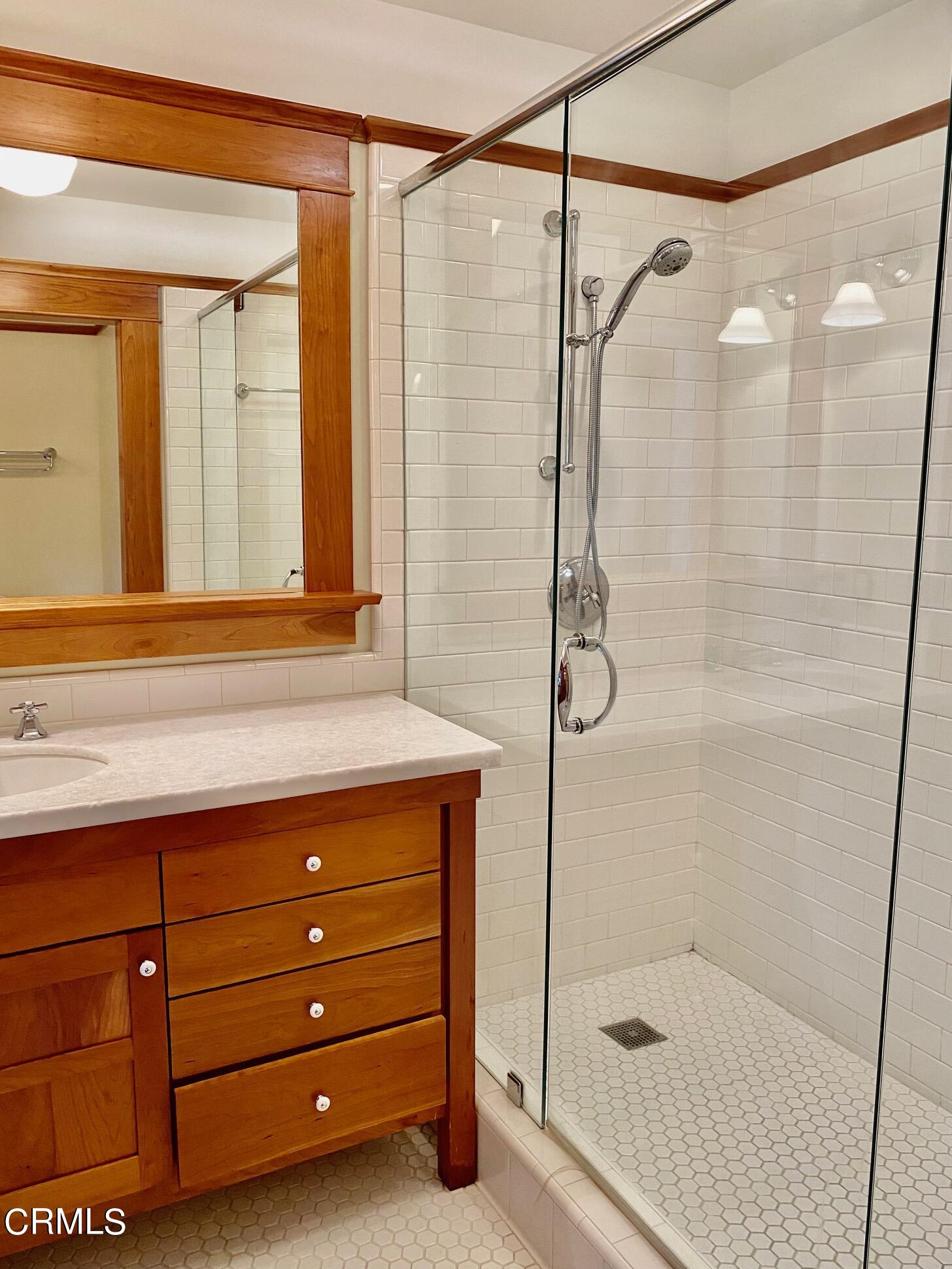 1361 Ridge Way Pasadena, CA 91106 - Photo 18 of 31 a bathroom with a shower a sink and a mirror