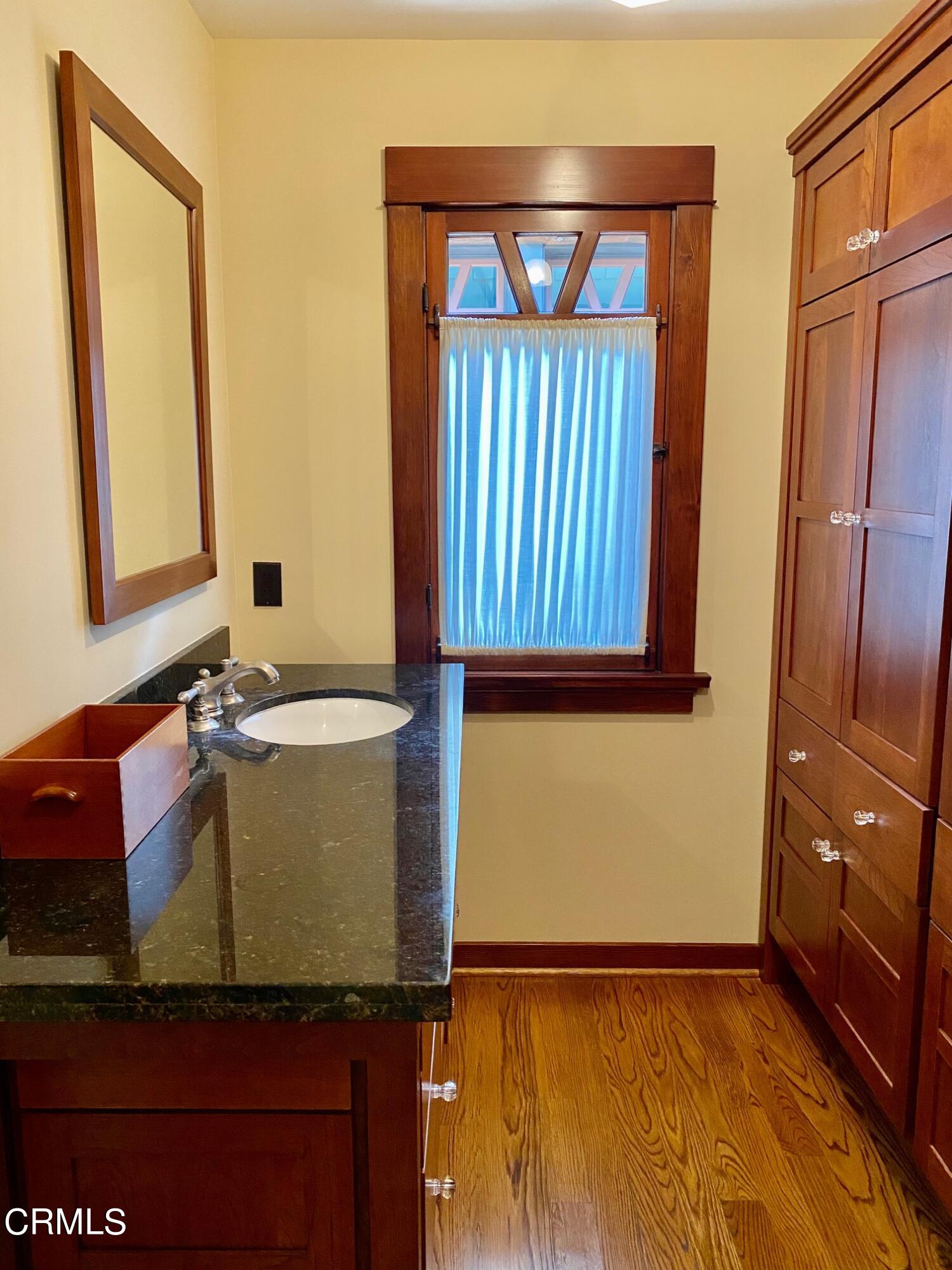 1361 Ridge Way Pasadena, CA 91106 - Photo 25 of 31 a bathroom with a granite countertop sink and a mirror