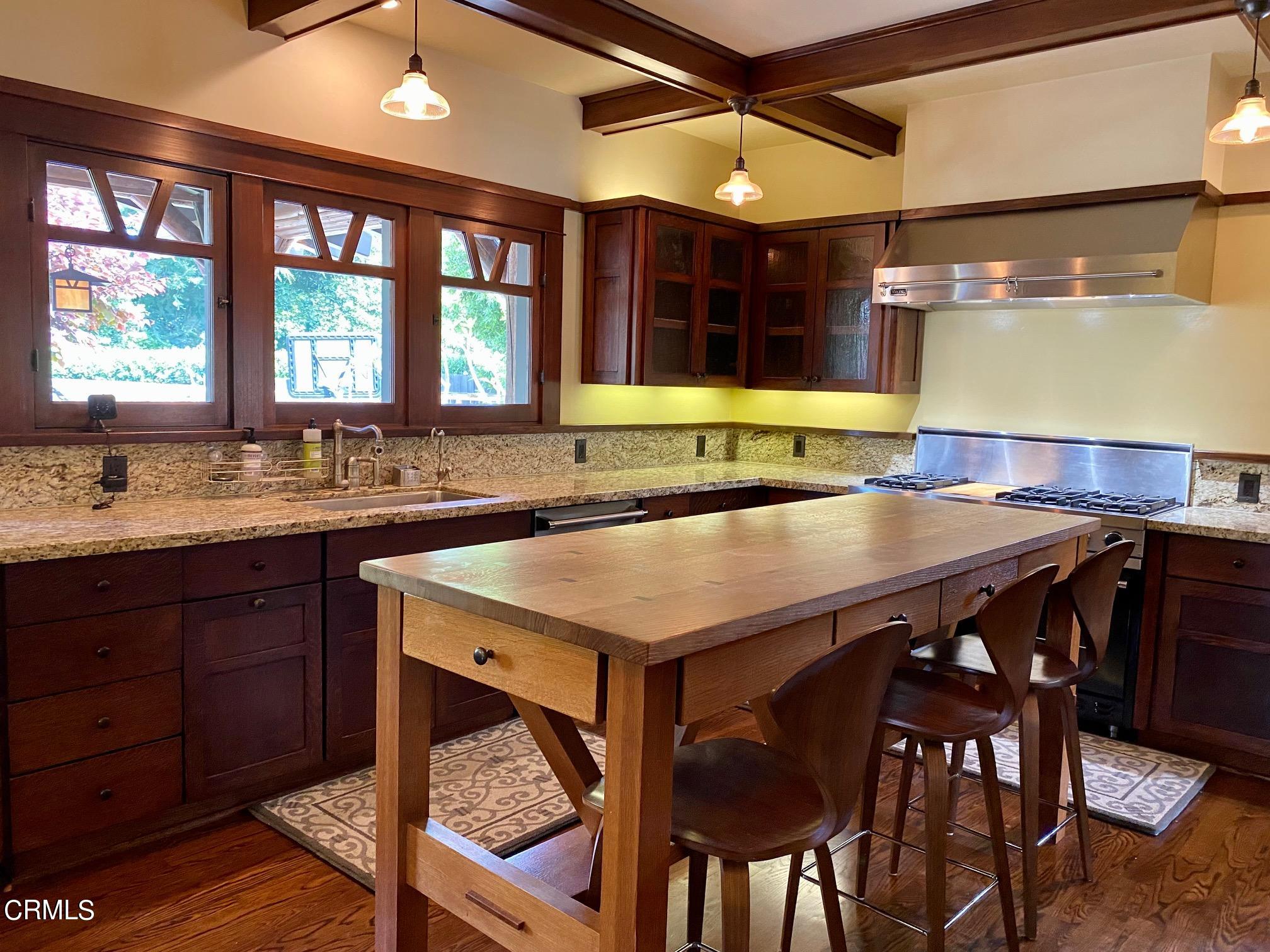 1361 Ridge Way Pasadena, CA 91106 - Photo 9 of 31 a kitchen with a table chairs sink and cabinets