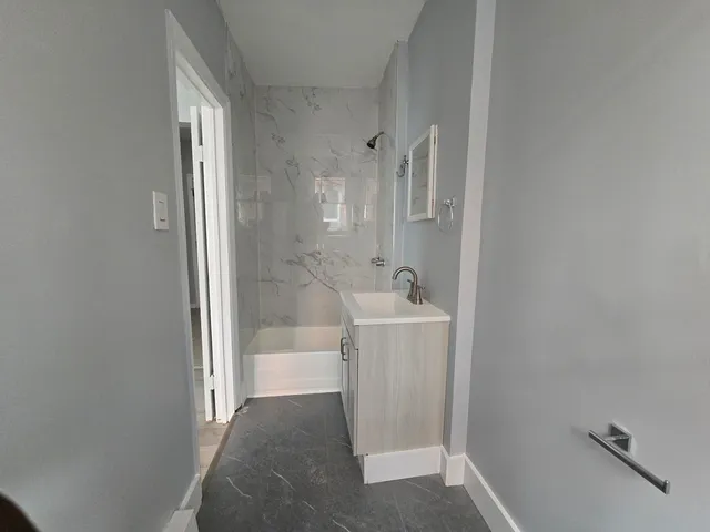 a bathroom with a sink and shower