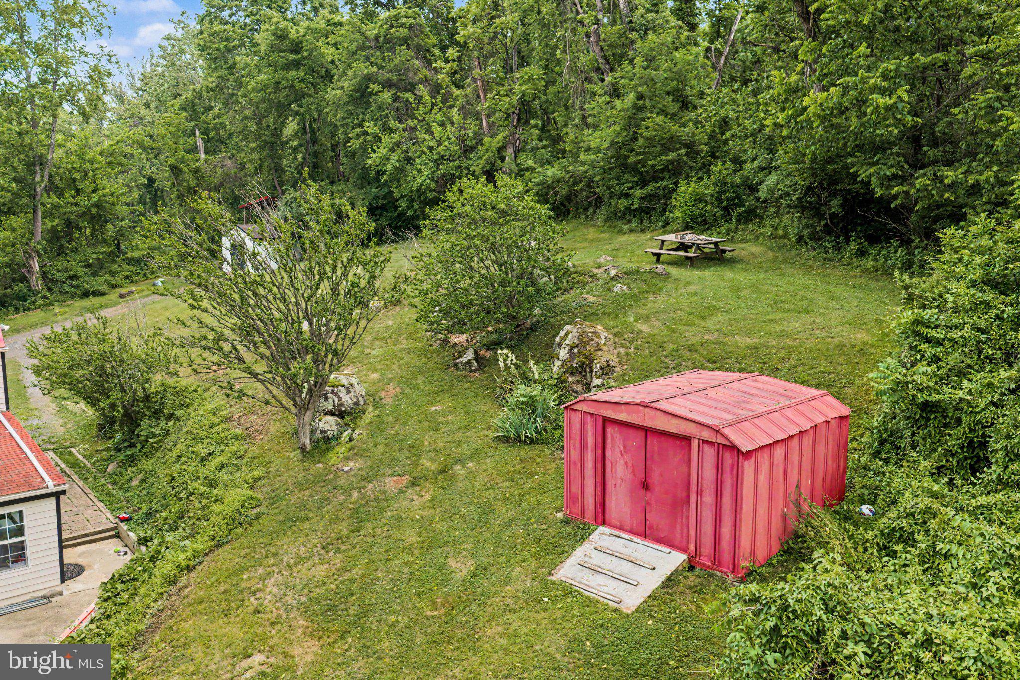 6287 Old Zion Road Warrenton, VA 20187 - Photo 33 of 69 Charming red shed in lush greenery.