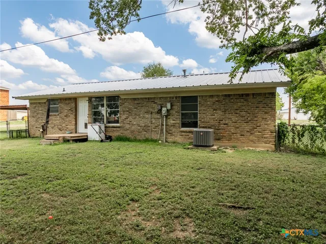 an aerial view of residential house with outdoor space and trees