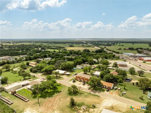 an aerial view of a house with a yard