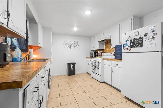 a kitchen with cabinets and white appliances