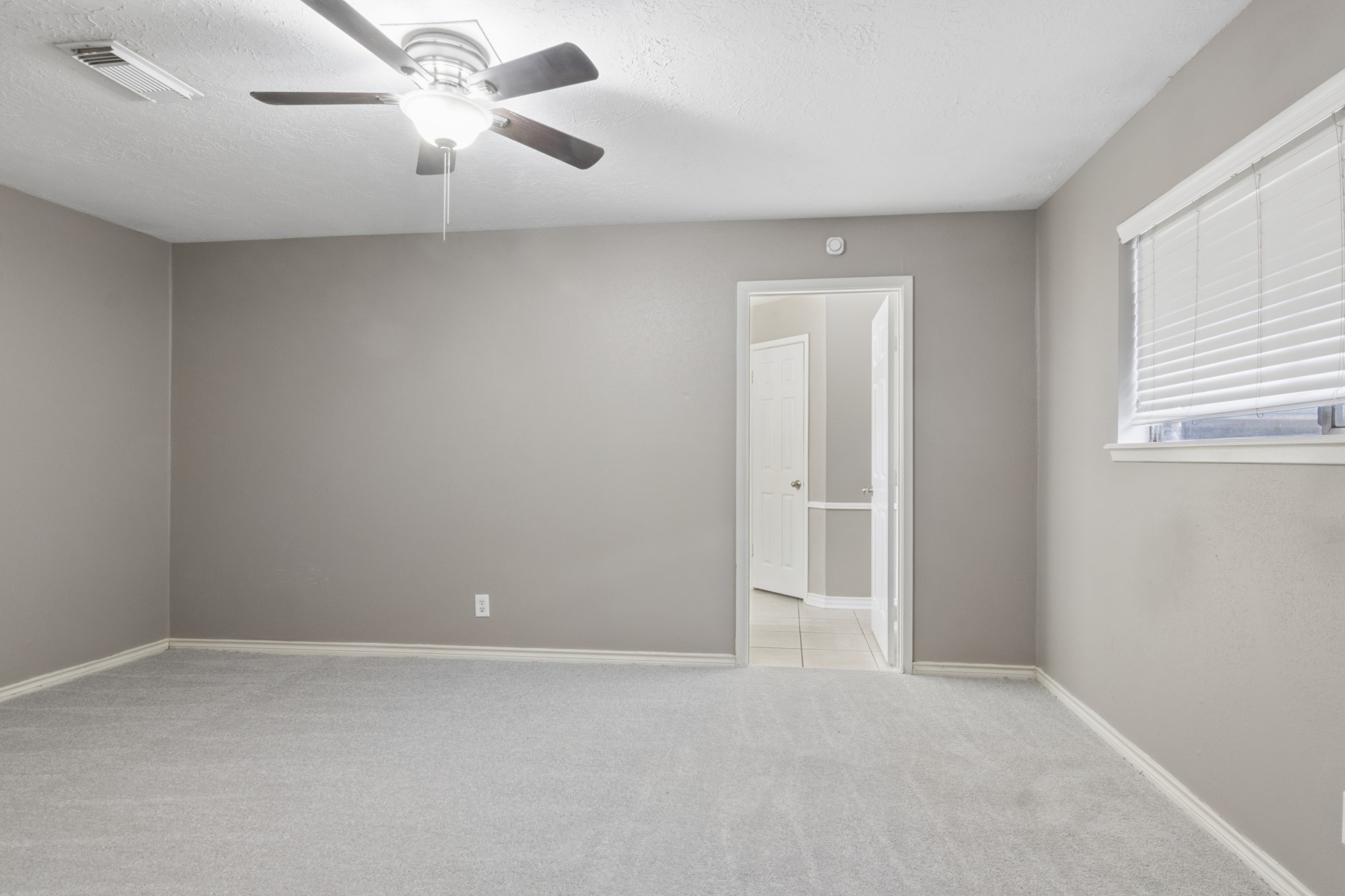 2607 Allyson Court Spring, TX 77373 - Photo 17 of 25 an empty room with a window and a fan