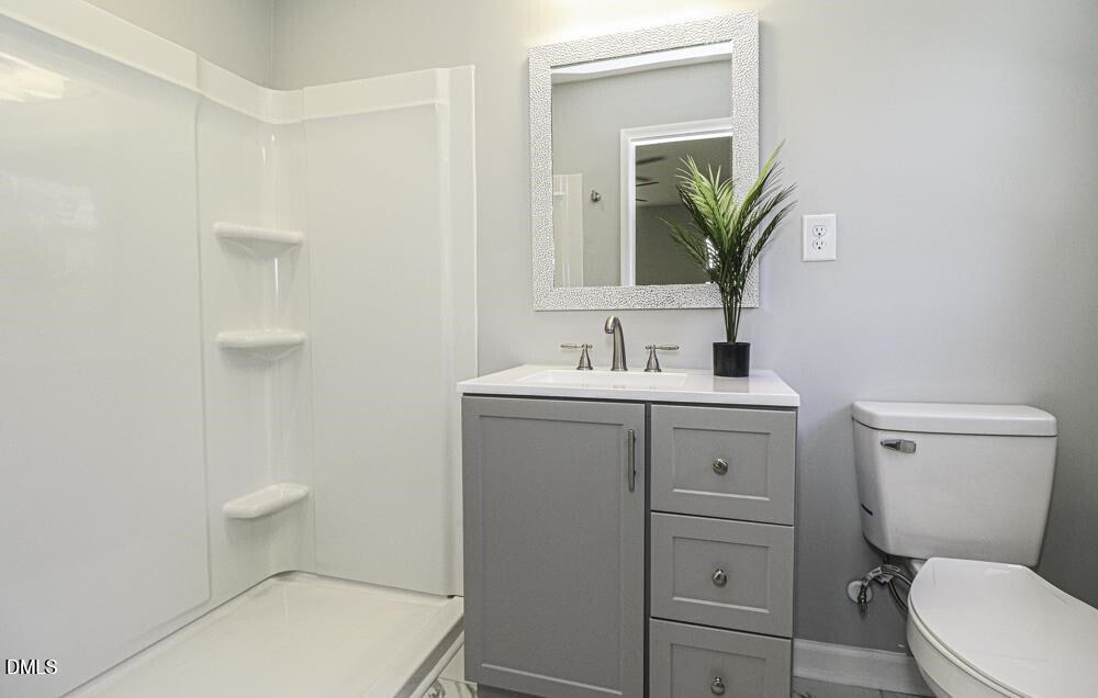 805 River Road Selma, NC 27576 - Photo 28 of 39 a bathroom with a sink a toilet and mirror