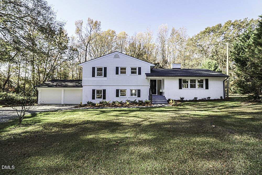 805 River Road Selma, NC 27576 - Photo 2 of 39 a view of a big house with a big yard and large trees