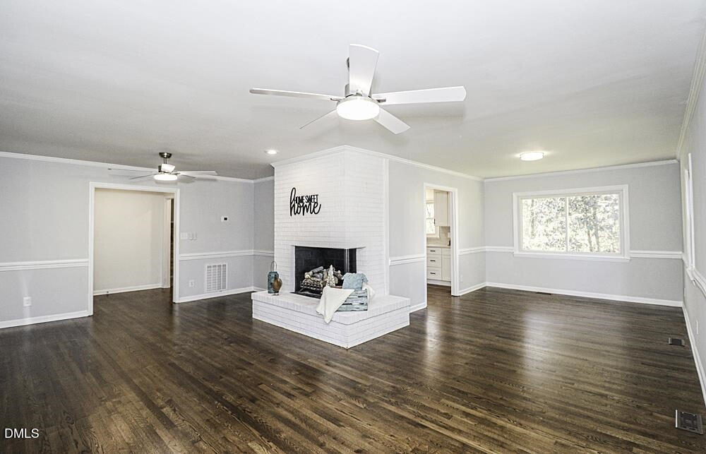 805 River Road Selma, NC 27576 - Photo 8 of 39 an white room with wooden floor and white walls