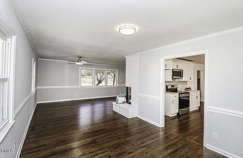 805 River Road Selma, NC 27576 - Photo 9 of 39 an empty room with wooden floor and windows