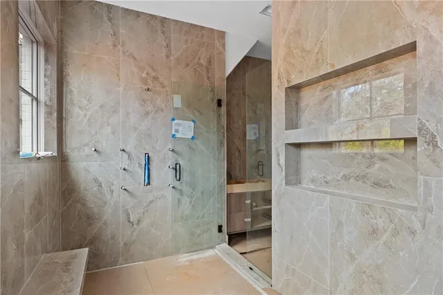 a bathroom with a sink a shower and a mirror