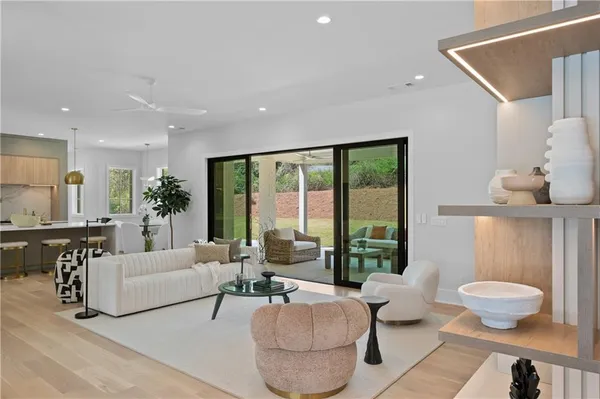 a open kitchen with stainless steel appliances kitchen island granite countertop a table and chairs in it