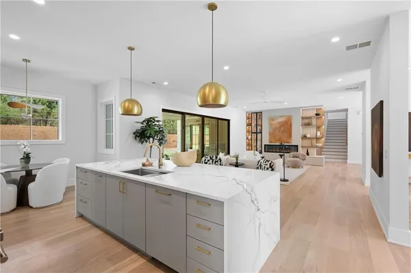 a kitchen with kitchen island a counter top space a sink and a refrigerator