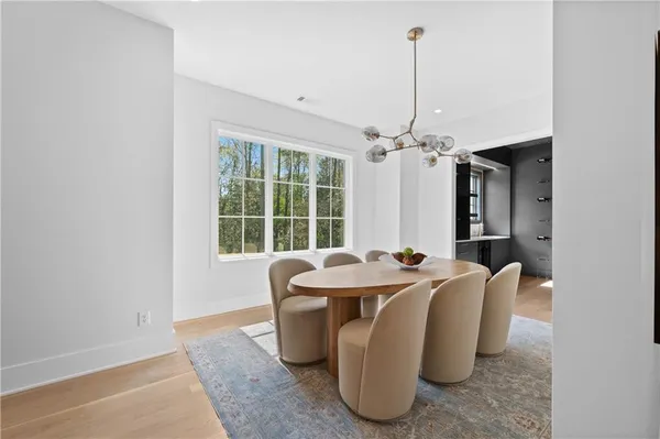 a view of empty room with wooden floor and windows