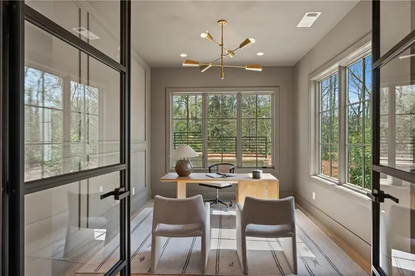 a dining room with furniture and wooden floor