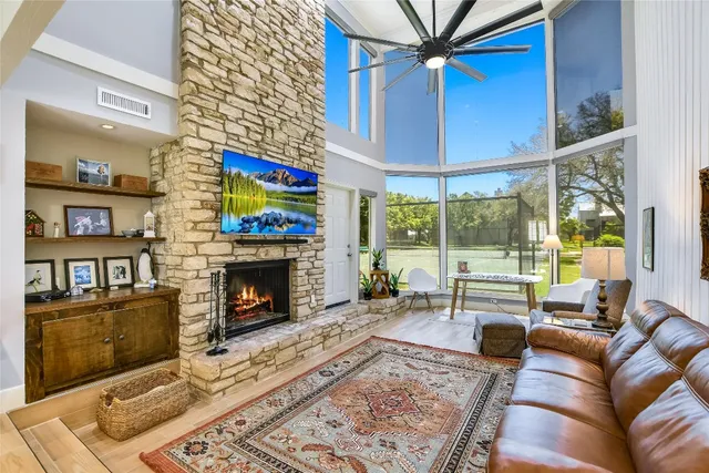 a living room with furniture a fireplace and a flat screen tv