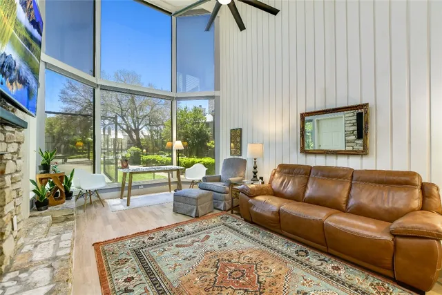a living room with furniture and a floor to ceiling window