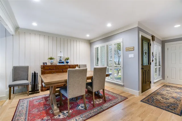 a dining room with furniture a rug and wooden floor