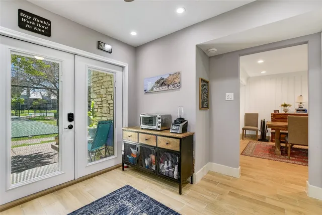 a living room with stainless steel appliances furniture stove and wooden floor