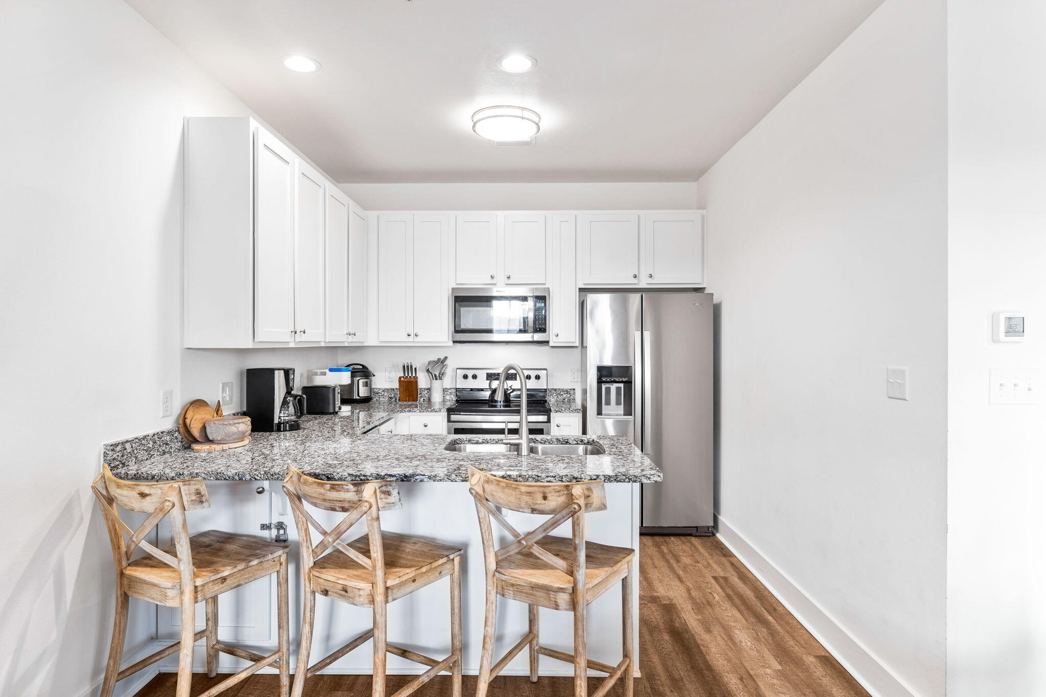 3958 West County Highway 30A, Unit 112 Santa Rosa Beach, FL 32459 - Photo 11 of 45 a kitchen with stainless steel appliances granite countertop a refrigerator and microwave