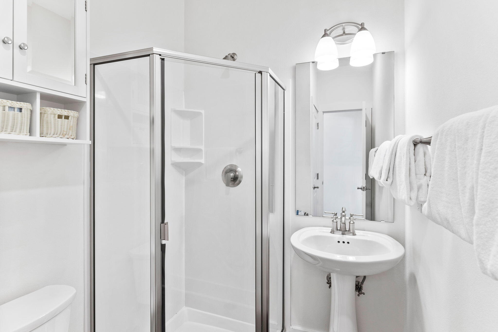 3958 West County Highway 30A, Unit 112 Santa Rosa Beach, FL 32459 - Photo 21 of 45 a bathroom with a sink a mirror and shower