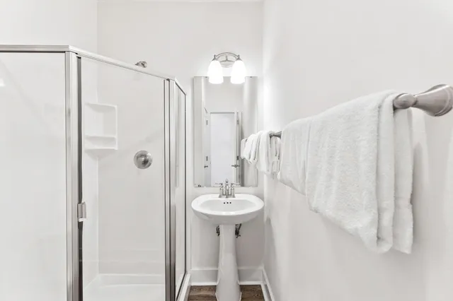 a bathroom with a sink a mirror and a shower