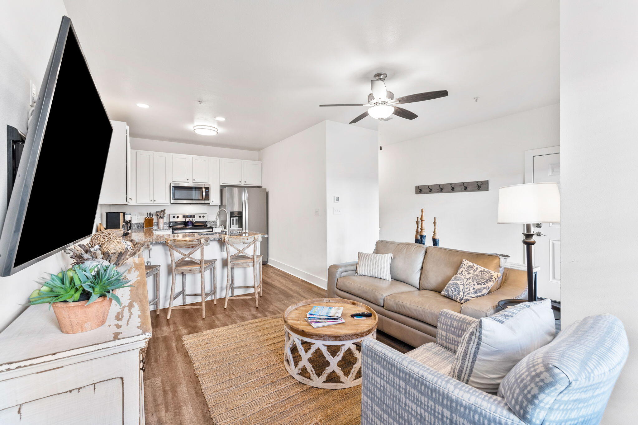 3958 West County Highway 30A, Unit 112 Santa Rosa Beach, FL 32459 - Photo 6 of 45 a living room with furniture a flat screen tv and a fireplace