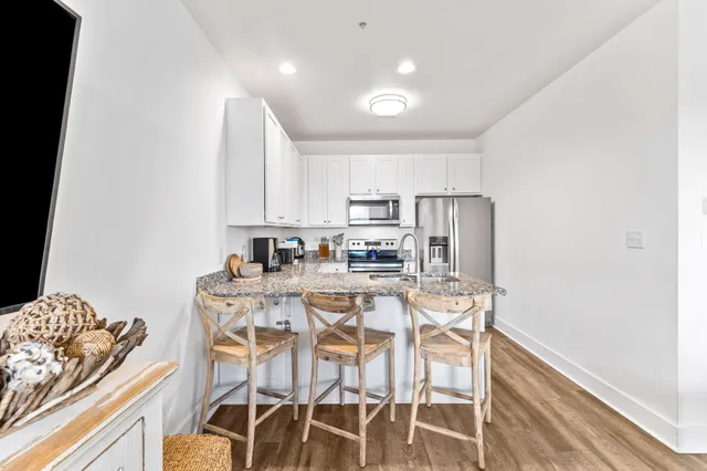 a dining room with furniture and kitchen view