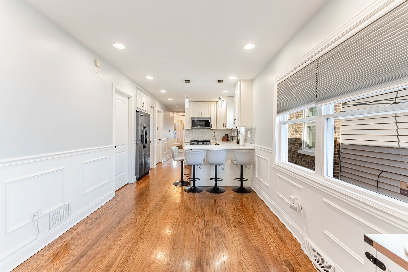 3605 West 56th Place Chicago, IL 60629 - Photo 3 of 23 a living room with stainless steel appliances furniture a rug and a kitchen view