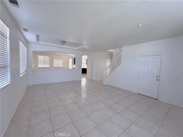 an empty room with windows and entrance