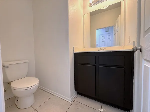 a bathroom with a toilet a sink and a window