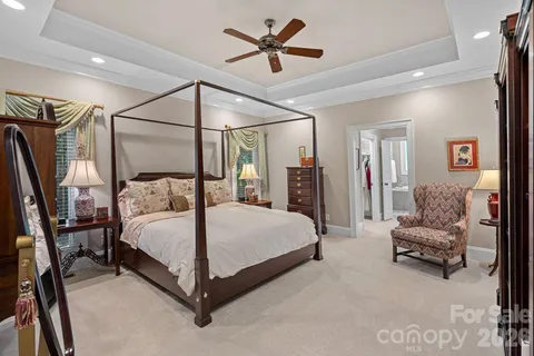 a bedroom with a bed couch and a walk in closet