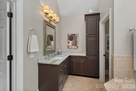 a bathroom with a sink vanity and a mirror