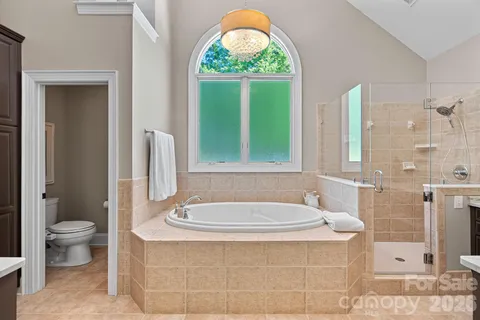 a bathroom with a tub a toilet and a sink