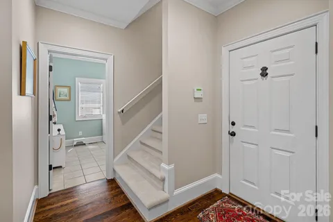 a view of entryway with wooden floor and a livingroom