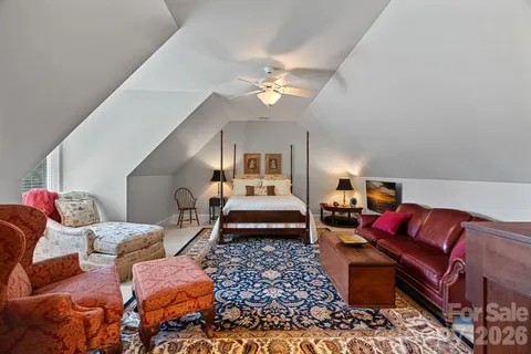 a living room with furniture a rug and a chandelier