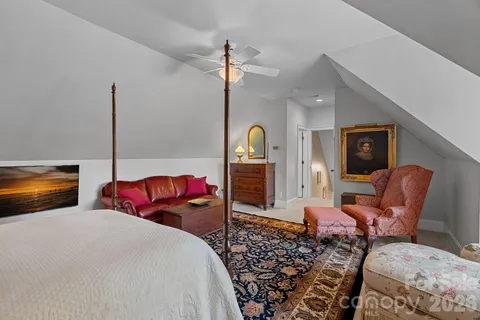 a bedroom with furniture and wooden floor