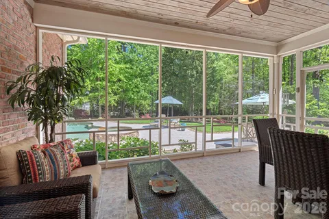 a living room with furniture and a floor to ceiling window