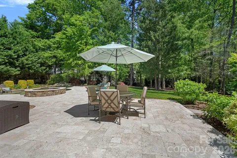a view of patio with table and chairs under an umbrella