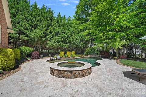 a view of a backyard with plants and patio