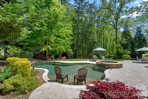 a view of a swimming pool and outdoor seating