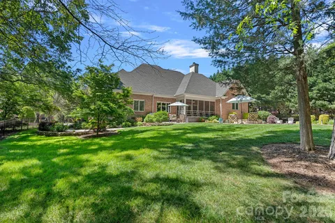 a view of house with yard and green space