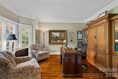a living room with furniture a large window and a flat screen tv