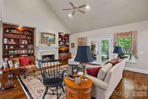 a living room with furniture fireplace and a window