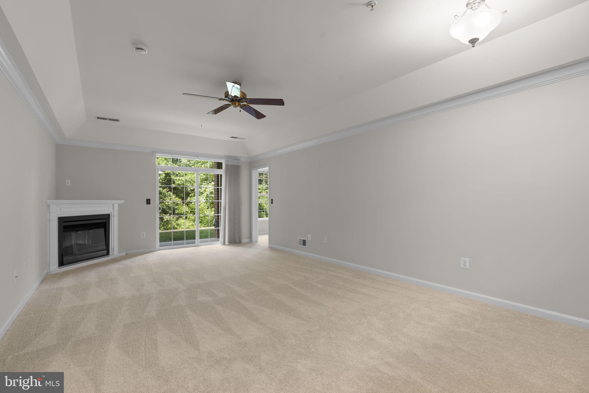 7315 Maplecrest Road, Unit 104 Elkridge, MD 21075 - Photo 10 of 58 an empty room with windows and fireplace