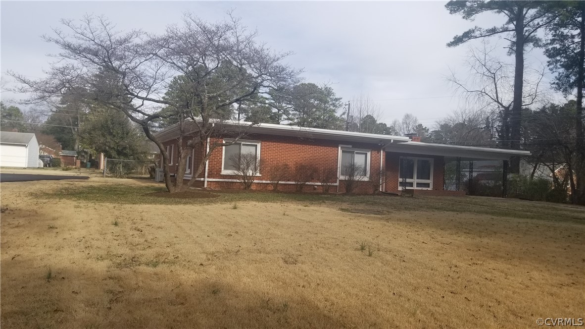 1104 Haverhill Road Richmond, VA 23227 - Photo 1 of 5 a front view of a house with a yard and garage