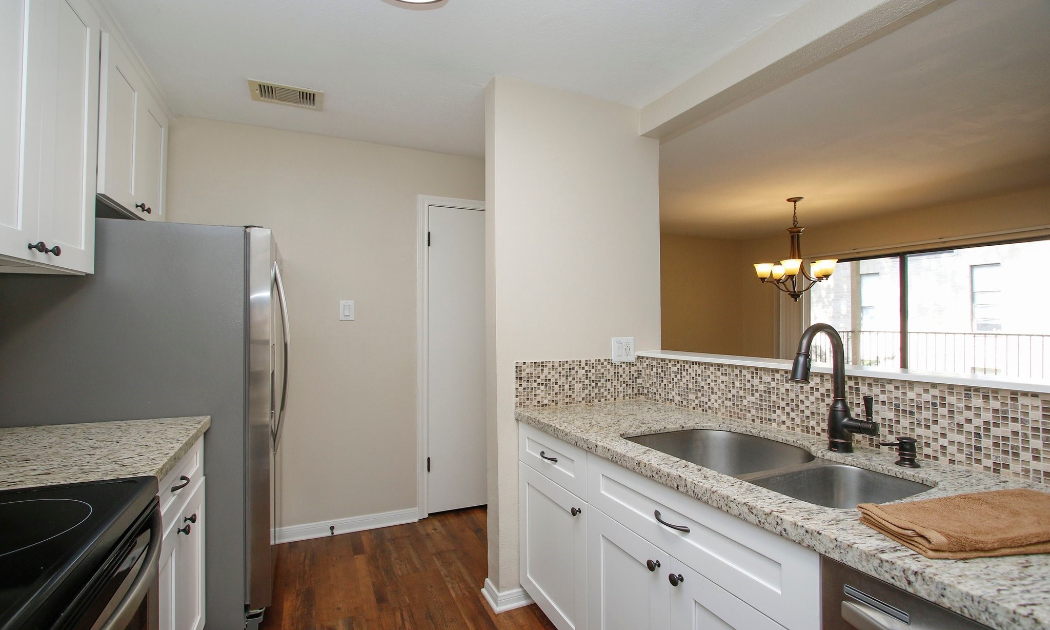 3500 Tangle Brush Drive, Unit 138 Spring, TX 77381 - Photo 12 of 28 a kitchen with granite countertop a sink and a refrigerator