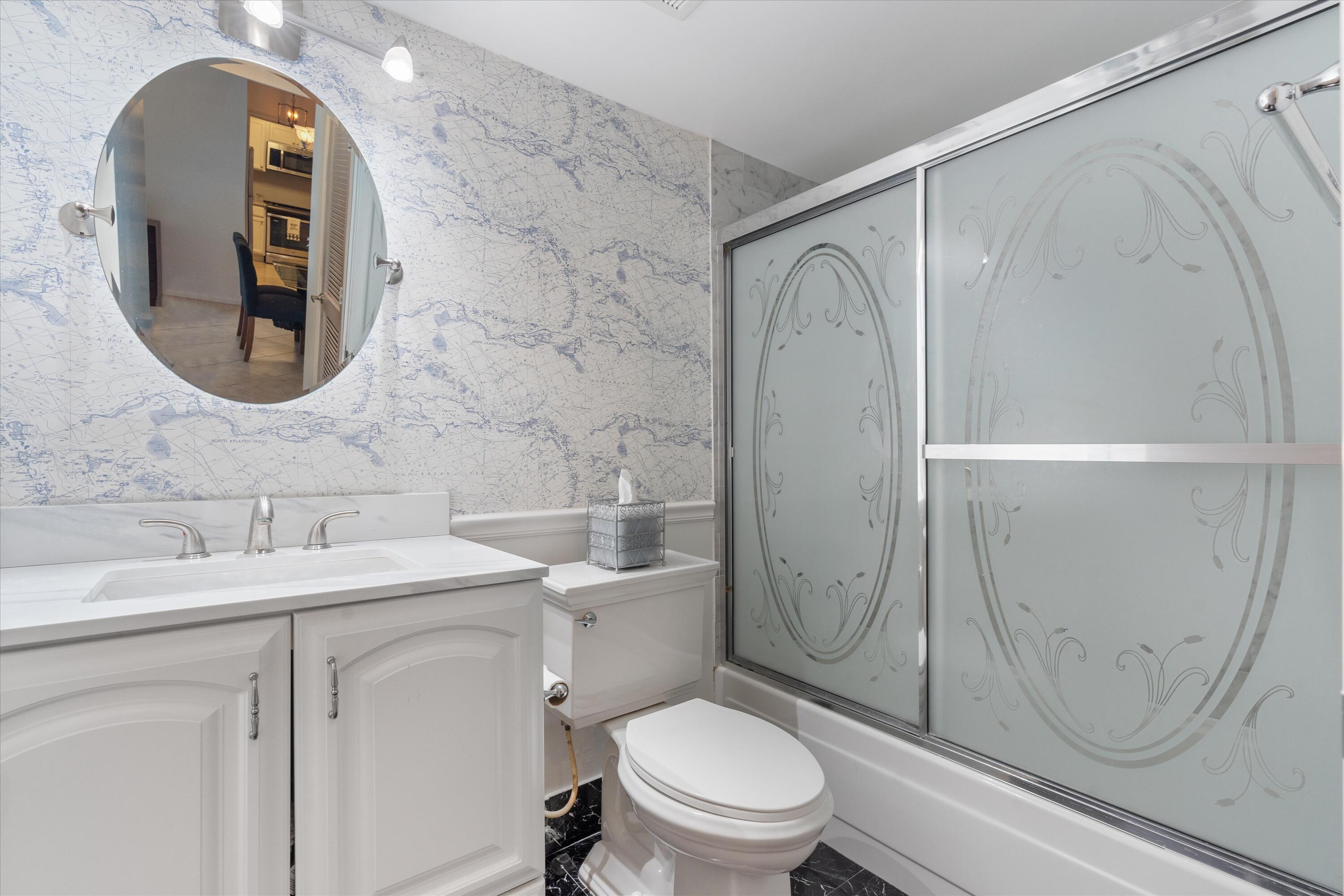 3301 South Ocean Boulevard, Unit 808 Highland Beach, FL 33487 - Photo 12 of 33 a bathroom with a sink a toilet and shower